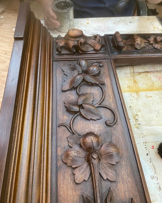 A new fireplace carved in the shop to match an old one that suffered fire damage, made out of walnut.